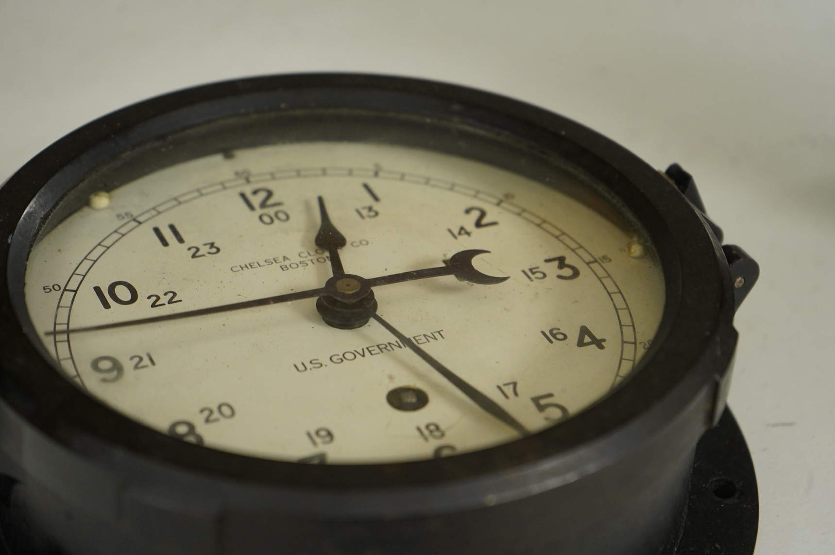 A U.S. Government Chelsea Clock Co., Boston, ship’s bulkhead clock in Bakelite case, diameter 17cm with key
